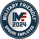 Circular emblem with the text "Military Friendly Spouse Employer 2024" around a red, white, and blue shield with a star and ribbon design, indicating recognition as a spouse-friendly military employer for the year 2024.